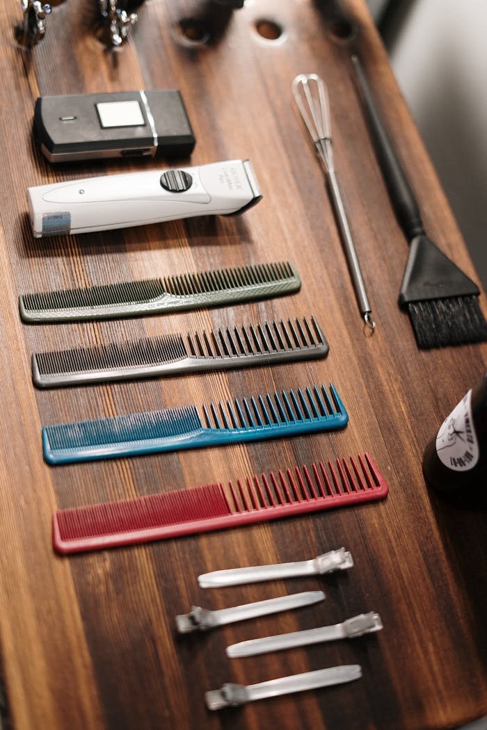 Organized collection of barber tools on a wooden table, ready for grooming.